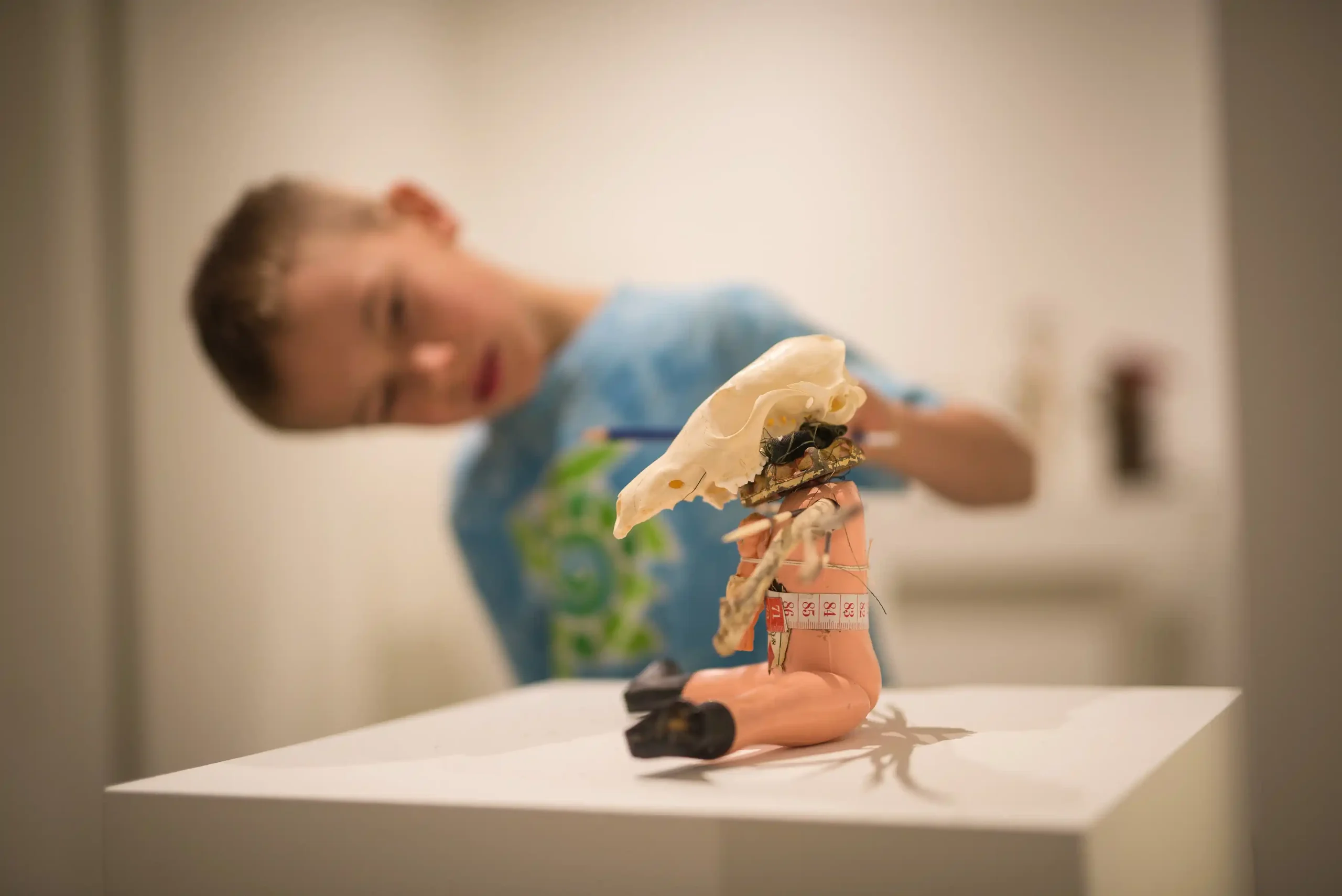 boy studies sculpture on a school tour